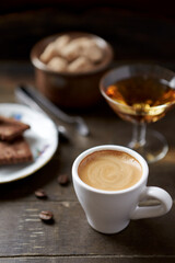 Cup of coffee on rustic wooden background. Soft focus. Close up. 