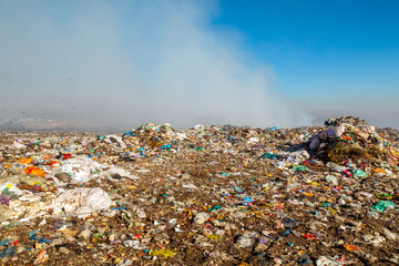 Burning trash piles in landfill