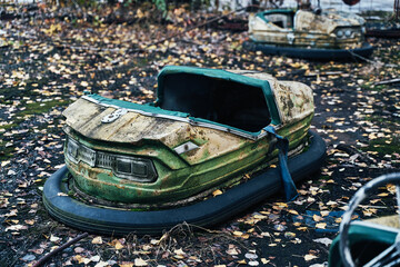 Abandoned Amusement Car Ride in Ghost City of Pripyat in Chernobyl Exclusion Zone, Scooter in Autumn Colors