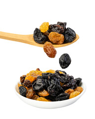 Raisin drops falling into a a ceramic bowl isolated on a white background, isolated on white background