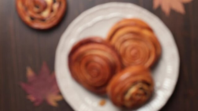 Homemade buns with cinnamon and raisins. Fika. Smooth focus on sharpness. Close-up, top view