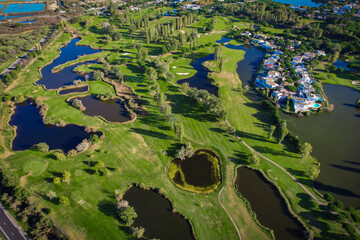 Aerial view of the salt marshes of the Camargue in southern France with plush beautiful golf course...