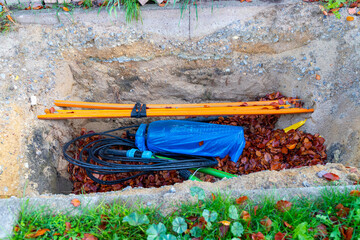 Construction hole with fiber optic cable and foliage