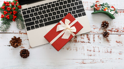 Christmas, office closed. bussiness desk. Laptop and xmas decoration on wood background , top view