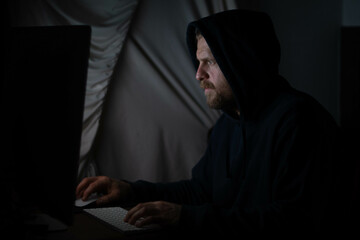 Hacker in the dark room on the pc