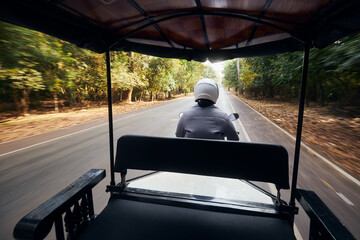 View from driving tuk tuk on road near Siem Reap in Cambodia..