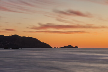 Fototapeta na wymiar Silhouette of San Francisco Bay Area Oceanside Cliffs During Sunset