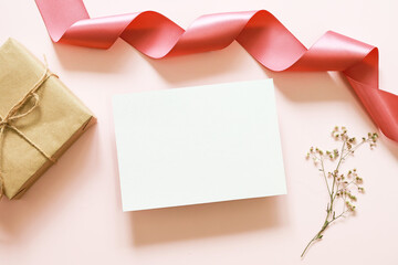 white blank card , gift box and grass flower on pink background