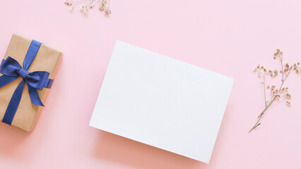 white blank card , gift box and grass flower on pink background