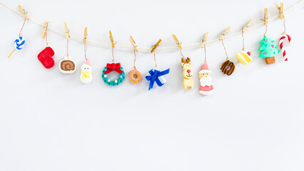 Christmas decoration hanging on rope on white background