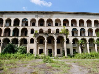 Fototapeta na wymiar Facade of abandoned Soviet sanatorium Iveria in Tskaltubo, Georgia.