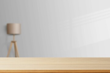 Empty wooden table against a gray background with a lamp and copy space