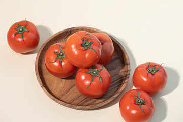 Tomatoes isolated on beige background.