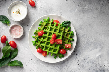 Savory spinach waffles with greek yogurt on gray table. Plant based diet concept. flat lay, copy...