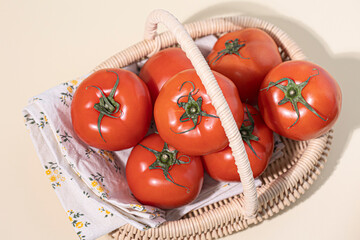 Red tomatoes in a basket isolated