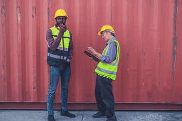 Old Asian worker, American African worker in business containers shipping yard, workers in containers shipment import export