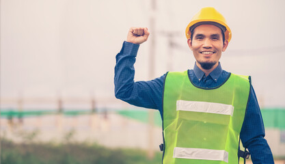 Asian Engineer standing outdoor on site construction posting confident , Engineer construction happy job success with in target planning