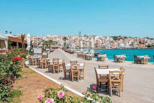 sitia, crete island, greece: waterfront pier with taverna tables and fishermen boats