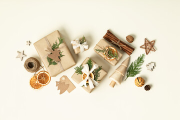 Natural color Christmas gift boxes on beige background, eco friendly trendy zero waste packaging...