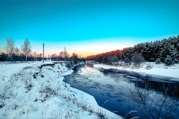 Ice drift on the river on a spring day in the forest near birch trees. Concept of spring floods.