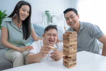 Happy Asian family doing activities together at home on vacation, Caring and encouraging special children, Down syndrome, Autism.