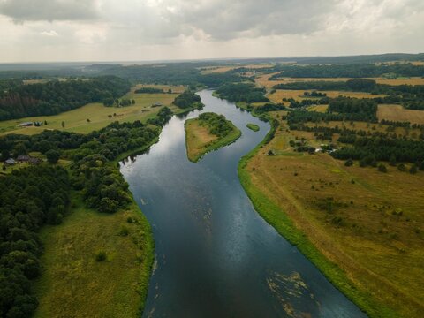 Aerial shot of Neris River in Kernave, Lithuania under a cloudy sky