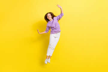 Fototapeta na wymiar Full length photo of overjoyed lady wear violet comfort clothes raise hand cool party holiday weekend isolated on yellow color background