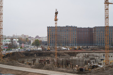 construction equipment is located in the city center in a modern residential complex. The cranes...