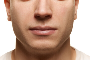 Obraz premium Close-up portrait of male face. Cropped image of nose and lips isolated over white studio background. Taking care after skin