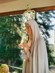 Statue of the Virgin Mary praying with her hands joined ,with a crown. Our Lady of Fatima. Paray-le-Monial, France.
