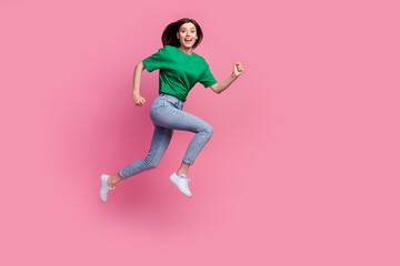 Full size profile photo of cheerful energetic girl jump rush empty space isolated on pink color...