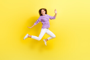 Full length photo of overjoyed lady wear trendy violet knitted sweater good mood weekend holiday isolated on yellow color background