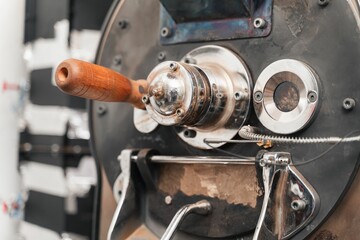 Closeup of a part of coffee roastery equipment with metallic texture