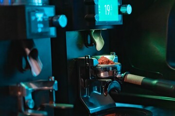 Closeup of a part of coffee roastery equipment with metallic texture, blue lights on
