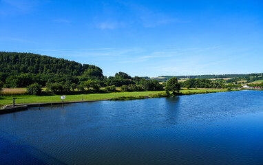 View from the Wilhelmshausen lock in the Fulda valley in Hesse. Landscape at the Fulda with the surrounding nature.
