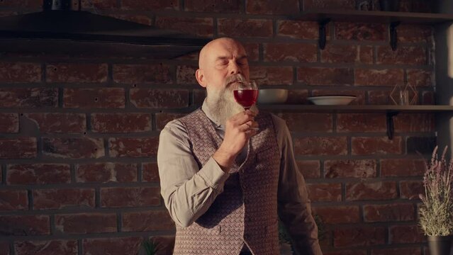 male sommelier evaluating the taste qualities of red wine.