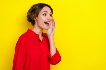 Portrait of impressed nice cute girl with bob hairdo dressed red shirt shout yell look empty space...