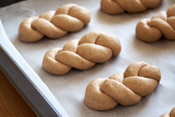 Praparation of braided bread buns from whole grain spelt flour