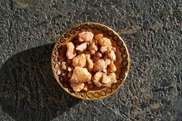 Styrax benzoin resin in a bow on dark background