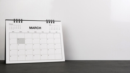 March calendar on wood desk white background.
Mar 2023 agenda concept.