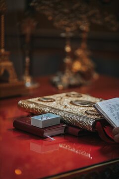 Closeup of holy books near wedding rings in church