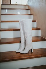 White heeled boots on staircases