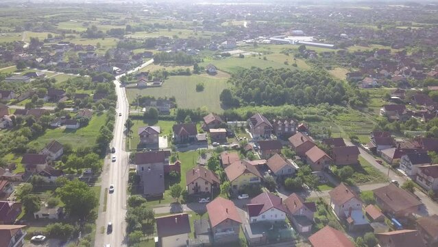 Aerial of a busy street surrounded by trees and houses in the Brcko district, Bosnia and Herzegovina