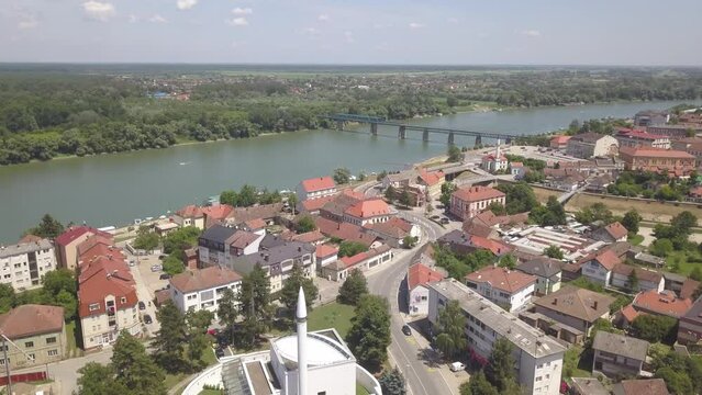 Aerial of a river in the Brcko district with a bridge connecting the lands, Bosnia and Herzegovina