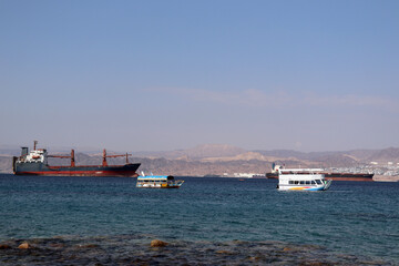 Fototapeta premium Aqaba, Jordan - cargo ship in the Red Sea (Gulf of Aqaba)