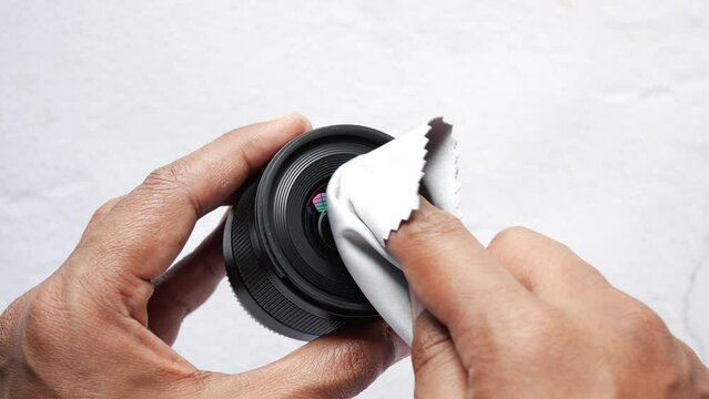 top view of cleaning a camera lenses with a cleaning cloth 