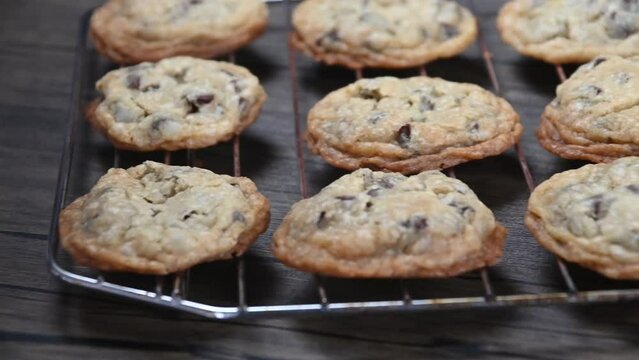 Freshly baked eggless chocolate chip cookies on a cooling tray