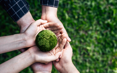 Naklejka na ściany i meble Top View Hands of People Embracing a Handmade Globe for Protecting Planet Together in World Earth Day Concept. Green Energy, ESG, Renewable, and Sustainable Resources. Environmental Care.
