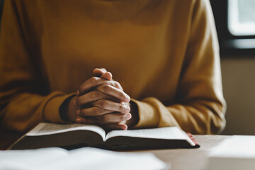 Christian life crisis prayer to god. Woman holding hands pray for god blessing to wishing have a better life on a wooden table. Woman hands praying to god with the bible. believe in goodness.