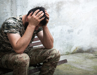 Sad soldier sits on the bench